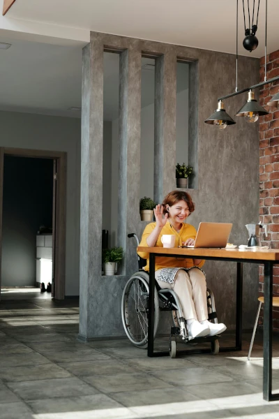 Woman in an orange tank top sitting on a black wheelchair