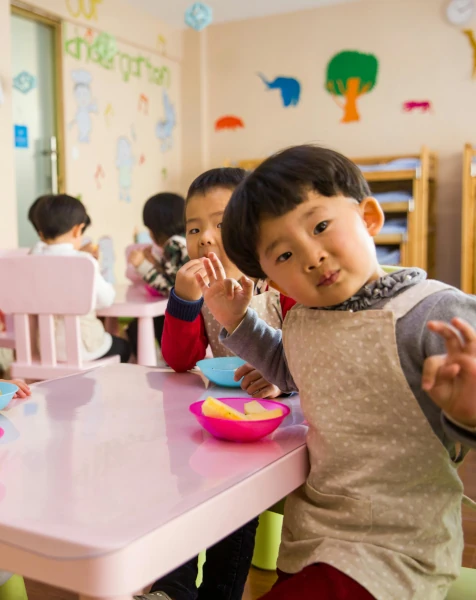 A group of small children eating lunch