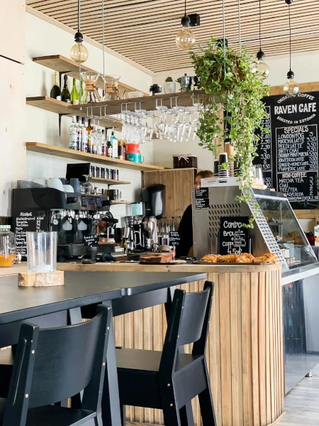 A black wooden dining table in a cafe