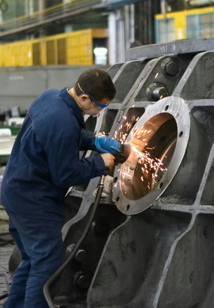 Man welding a round window frame