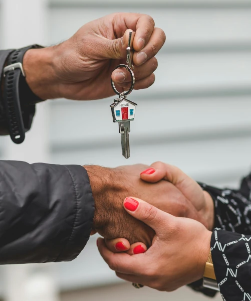 Person holding a silver key