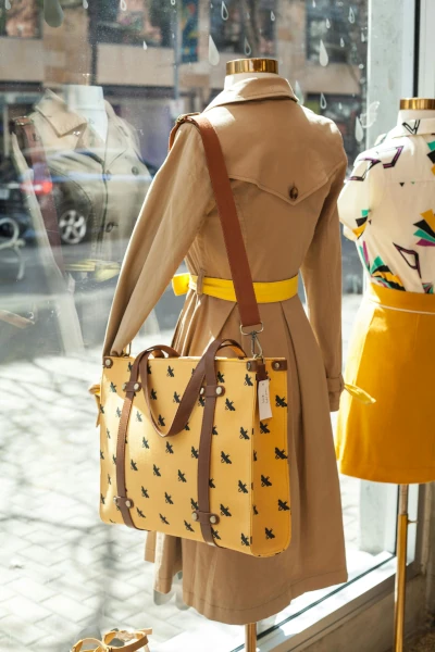 A yellow and black leather bag in a retail store window